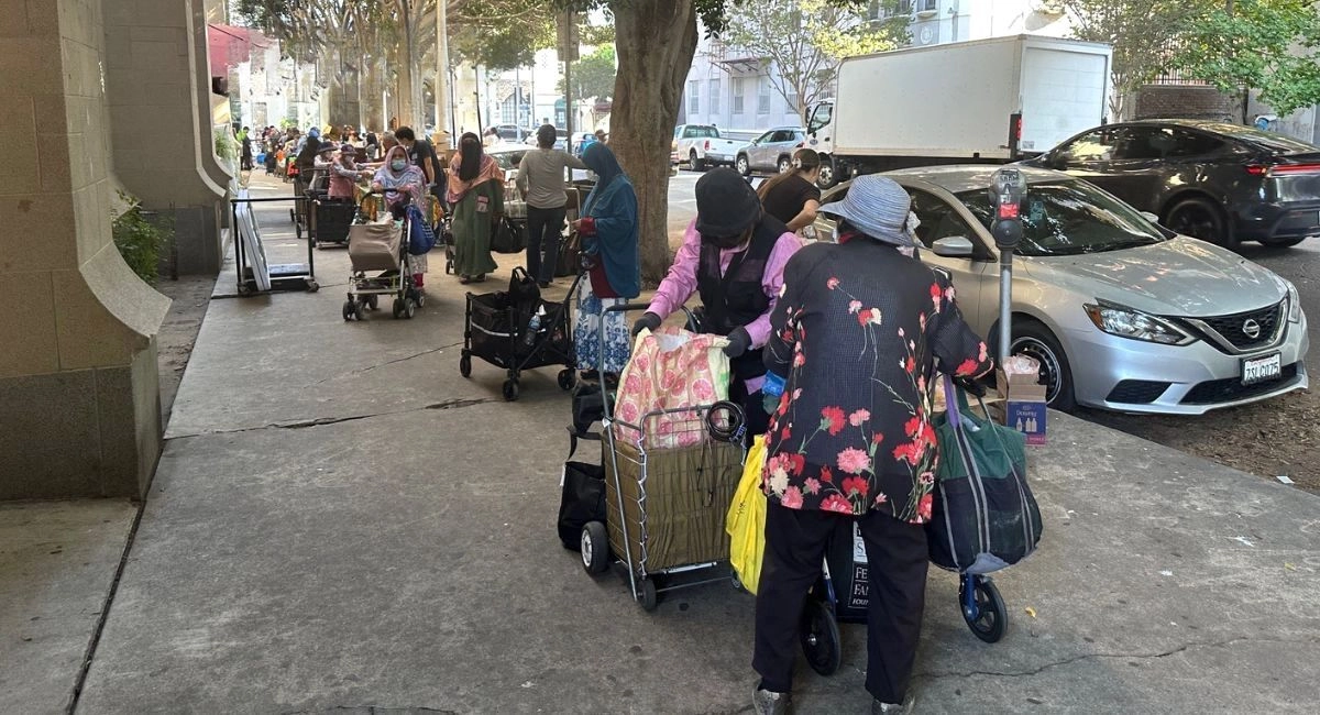 Volunteers carry food to houses of families immigrants that fear exit by raids