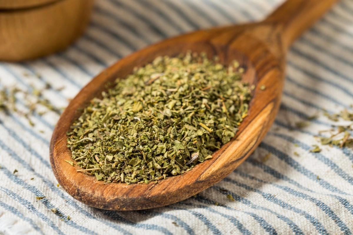 What is the purpose of sprinkling oregano down the dishwasher drain
