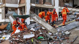 Rescue teams in Venezuela rush to save security guard trapped under building